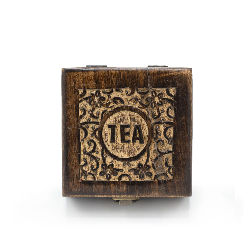 Small carved wooden tea box with brass clasp